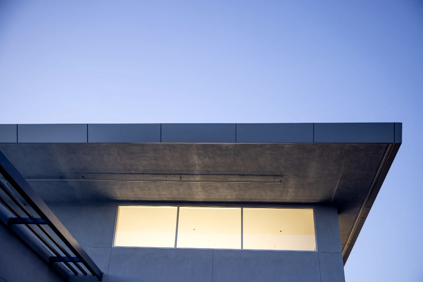 Concrete cantilever of a modern building at dusk
